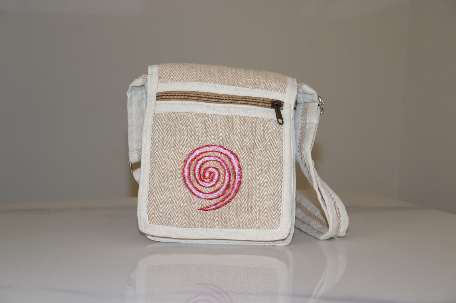 Bohemian woven crossbody bag with pink spiral embroidery