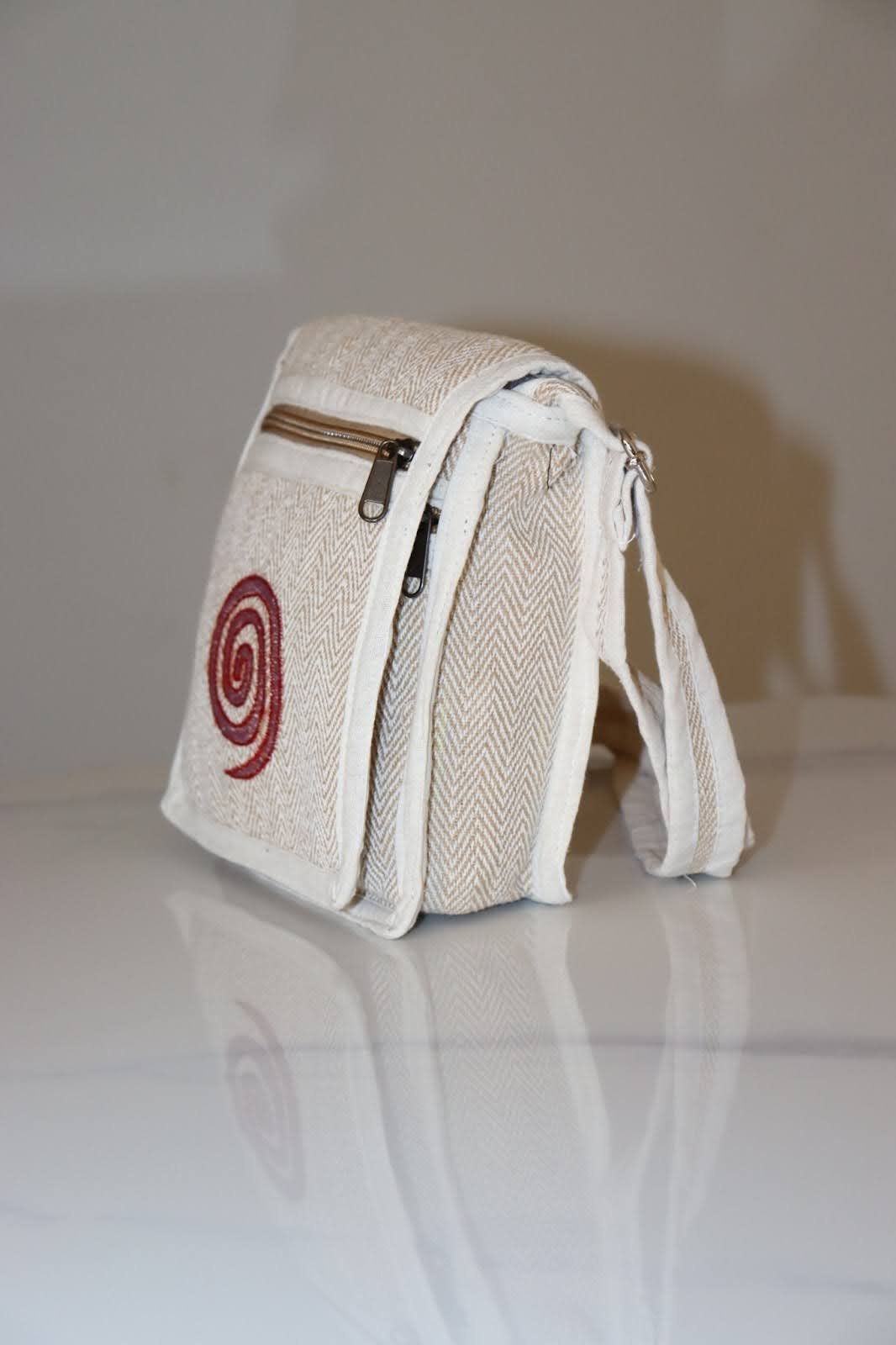 Bohemian woven crossbody bag with pink spiral embroidery